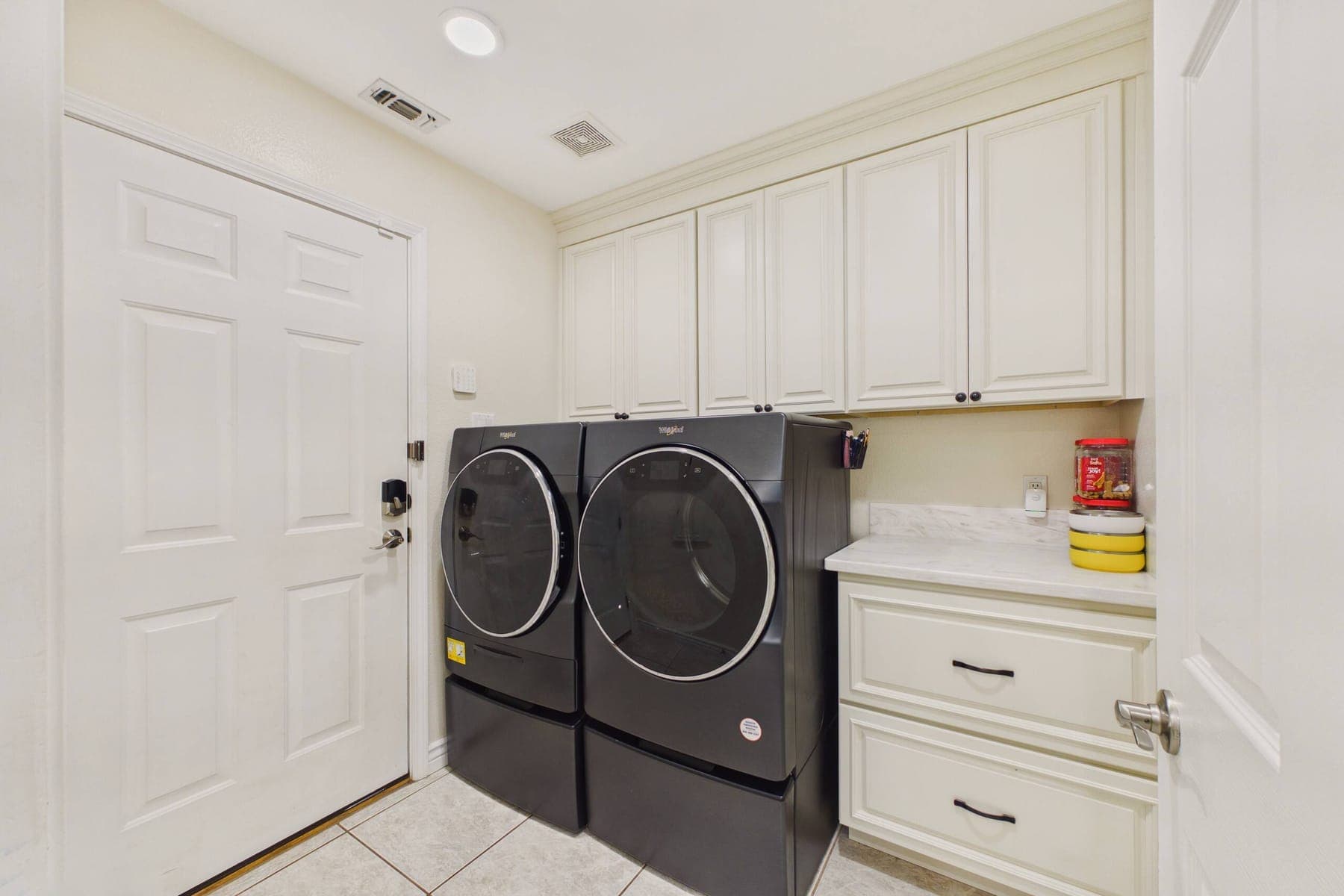 The laundry area, set into a cabinet alcove off the dining room.